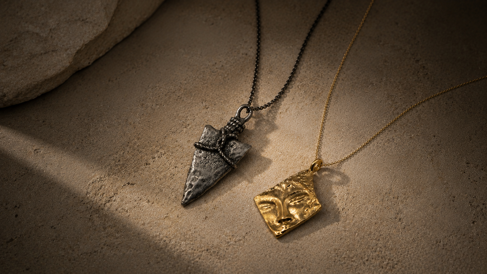 Two symbolic necklaces arranged in a quiet layered editorial composition