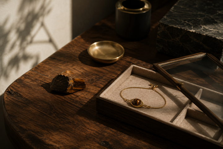 Quiet luxury jewelry styled with natural stones and restrained neutral textures