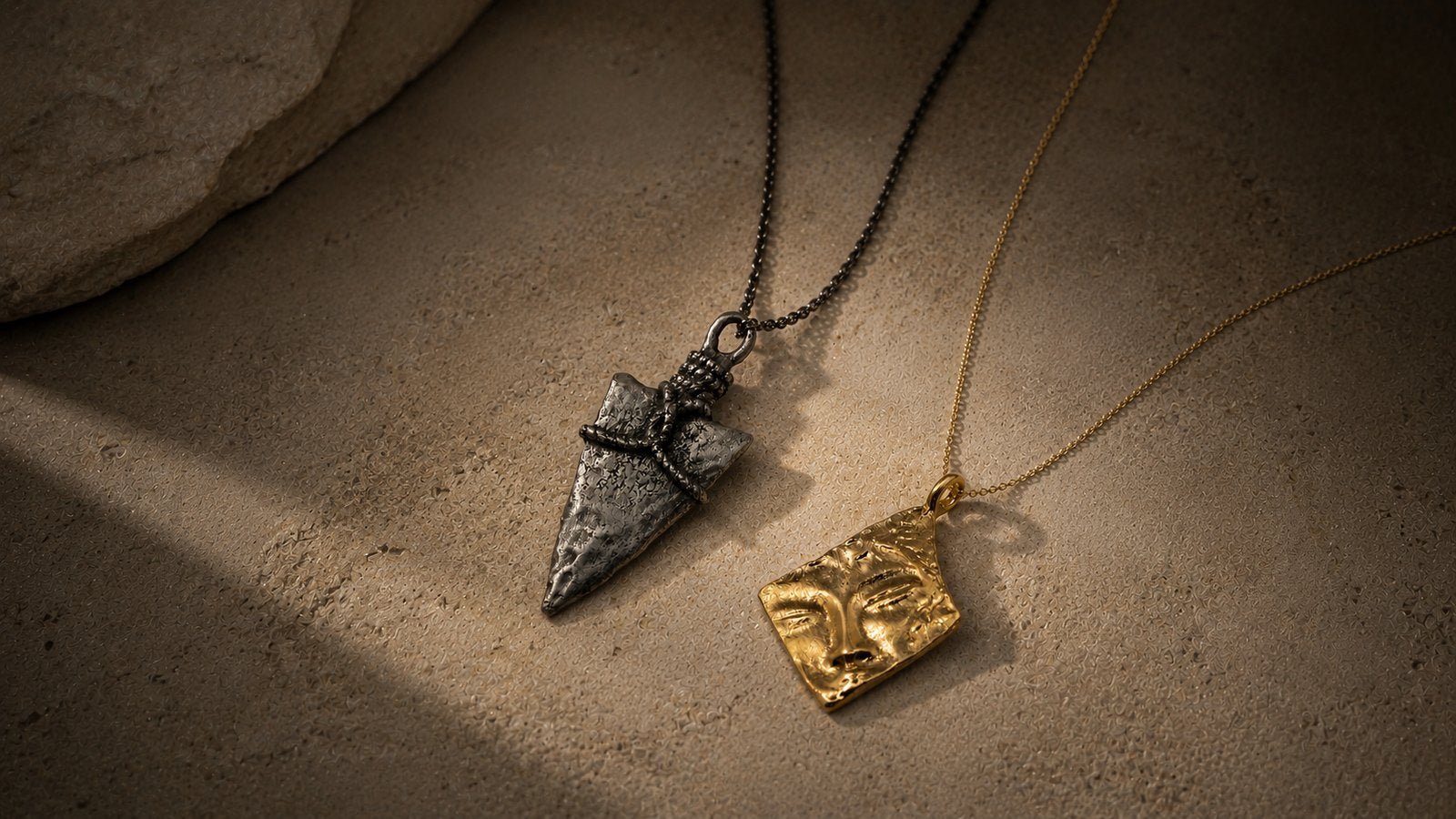 Two symbolic necklaces arranged in a quiet layered editorial composition
